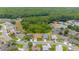 Desirable community homes bordering lush green space, trees, and pond at 7827 Starfire Way, New Port Richey, FL 34654