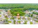 Aerial view showcases the property's location in a neighborhood with ponds and wooded areas at 7827 Starfire Way, New Port Richey, FL 34654