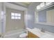 A bathroom featuring a vanity sink, toilet, and shower and bathtub combination at 7827 Starfire Way, New Port Richey, FL 34654