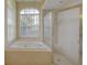 Bright bathroom featuring a garden tub, and separate glass shower at 7827 Starfire Way, New Port Richey, FL 34654