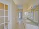 Clean, well-lit bathroom featuring double sinks and a neutral color scheme at 7827 Starfire Way, New Port Richey, FL 34654