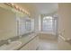 Bright bathroom featuring a double sink vanity, garden tub, and separate shower at 7827 Starfire Way, New Port Richey, FL 34654