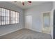 This bedroom features neutral walls, carpet, window with blinds and closet at 7827 Starfire Way, New Port Richey, FL 34654