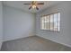 The bedroom features carpet flooring, light-colored walls, and a window at 7827 Starfire Way, New Port Richey, FL 34654