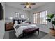 This primary bedroom boasts calming gray walls, carpet flooring, and a window at 7827 Starfire Way, New Port Richey, FL 34654