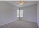 The bedroom features carpet flooring, light-colored walls, and a window at 7827 Starfire Way, New Port Richey, FL 34654