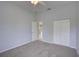 The bedroom features carpet flooring, light-colored walls, and closet at 7827 Starfire Way, New Port Richey, FL 34654