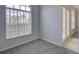 This bedroom features neutral walls, carpeted floors, window with blinds and glass paneled doors at 7827 Starfire Way, New Port Richey, FL 34654