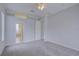 Spacious bedroom with neutral gray carpet and paint and an attached bathroom at 7827 Starfire Way, New Port Richey, FL 34654