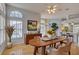 The dining room features light hardwood floors, a decorative light fixture, and a beautiful view at 7827 Starfire Way, New Port Richey, FL 34654