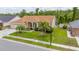 Well-kept home with a manicured lawn, landscaped bushes, and a welcoming two-car garage at 7827 Starfire Way, New Port Richey, FL 34654