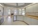 Open kitchen with stainless steel appliances, white cabinetry, and views into the living room at 7827 Starfire Way, New Port Richey, FL 34654