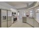 Bright, open kitchen with stainless appliances and seamless flow into the living area with a fireplace at 7827 Starfire Way, New Port Richey, FL 34654