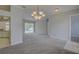 Relaxing living room with gray carpet and walls, showcasing a pool view at 7827 Starfire Way, New Port Richey, FL 34654
