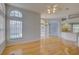 Bright open-concept living room with hardwood floors and view of the outdoor pool at 7827 Starfire Way, New Port Richey, FL 34654