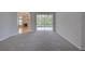 View of a cozy living room with fireplace that flows into the sunny backyard pool area at 7827 Starfire Way, New Port Richey, FL 34654