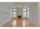 Bright living room featuring beautiful hardwood floors, decorative fireplace and high ceilings at 7827 Starfire Way, New Port Richey, FL 34654