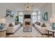 Staged living room featuring hardwood floors, decorative fireplace and comfortable seating at 7827 Starfire Way, New Port Richey, FL 34654
