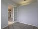 This home office has neutral walls, carpeted floors and glass paneled door at 7827 Starfire Way, New Port Richey, FL 34654