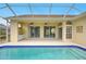 This screened-in pool offers ample outdoor space with multiple entrances at 7827 Starfire Way, New Port Richey, FL 34654