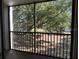 Relaxing balcony view with black railings and lush green scenery at 840 Virginia St # 202, Dunedin, FL 34698