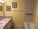 A bathroom with a tile shower, tub, and marble countertop vanity at 840 Virginia St # 202, Dunedin, FL 34698
