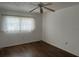 A bright bedroom featuring a ceiling fan and laminate flooring at 840 Virginia St # 202, Dunedin, FL 34698