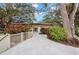 Beautiful home featuring a paved driveway, colorful landscaping and large tree at 840 Virginia St # 202, Dunedin, FL 34698