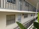 Multi-level condo building with black railings and tan exterior paint at 840 Virginia St # 202, Dunedin, FL 34698