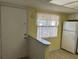 Kitchen with white cabinets, stainless steel appliances, and bright natural light at 840 Virginia St # 202, Dunedin, FL 34698