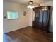 Open-concept living room with a ceiling fan, and beautiful wood flooring at 840 Virginia St # 202, Dunedin, FL 34698
