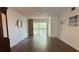 Spacious living room with hardwood floors and a private balcony at 840 Virginia St # 202, Dunedin, FL 34698