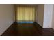 Bright living room featuring wood floors, neutral tones, and lots of light at 840 Virginia St # 202, Dunedin, FL 34698