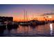 Beautiful sunset over the marina, with boats docked and reflections in the water at 840 Virginia St # 202, Dunedin, FL 34698