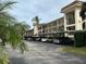 Exterior of building with covered parking spots for condo residents at 840 Virginia St # 202, Dunedin, FL 34698