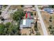 Aerial view highlighting the property with a screened pool and well-maintained surroundings at 8522 Inwood Dr, Hudson, FL 34667