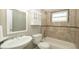 Bright bathroom features a white vanity, built-in cabinet, and tiled shower-tub combination at 8522 Inwood Dr, Hudson, FL 34667