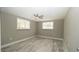 This bedroom features neutral walls, gray wood-look tile flooring, and a modern ceiling fan at 8522 Inwood Dr, Hudson, FL 34667
