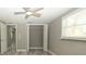 Neutral bedroom offers tile floors, fan, an open closet and ample natural light at 8522 Inwood Dr, Hudson, FL 34667