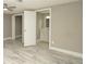 Bedroom with wood-look tile flooring, ceiling fan, and doorways to a closet and bathroom at 8522 Inwood Dr, Hudson, FL 34667