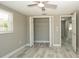 Bedroom with wood-look tile flooring, ceiling fan, window and closet at 8522 Inwood Dr, Hudson, FL 34667