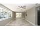 Dining room with wood-look tile flooring, ceiling fan, and large windows at 8522 Inwood Dr, Hudson, FL 34667