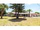 Quaint single-story home surrounded by mature trees and lush lawn at 8522 Inwood Dr, Hudson, FL 34667