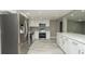 Renovated kitchen featuring stainless steel appliances and bright white cabinets and hardware at 8522 Inwood Dr, Hudson, FL 34667
