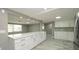 Modern kitchen featuring ample cabinet space, quartz countertops, and stainless steel appliances at 8522 Inwood Dr, Hudson, FL 34667