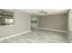 Living room with wood-look tile flooring and view to kitchen at 8522 Inwood Dr, Hudson, FL 34667