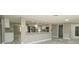 Open concept living room with a view into the renovated kitchen area with stainless steel appliances at 8522 Inwood Dr, Hudson, FL 34667