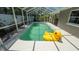 Relaxing screened pool area with a playful yellow duck float, perfect for sunny days at 8522 Inwood Dr, Hudson, FL 34667