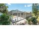 A screened-in pool with tropical foliage and greenery at 8522 Inwood Dr, Hudson, FL 34667