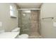 Tiled shower with pebble floor and glass doors at 8522 Inwood Dr, Hudson, FL 34667